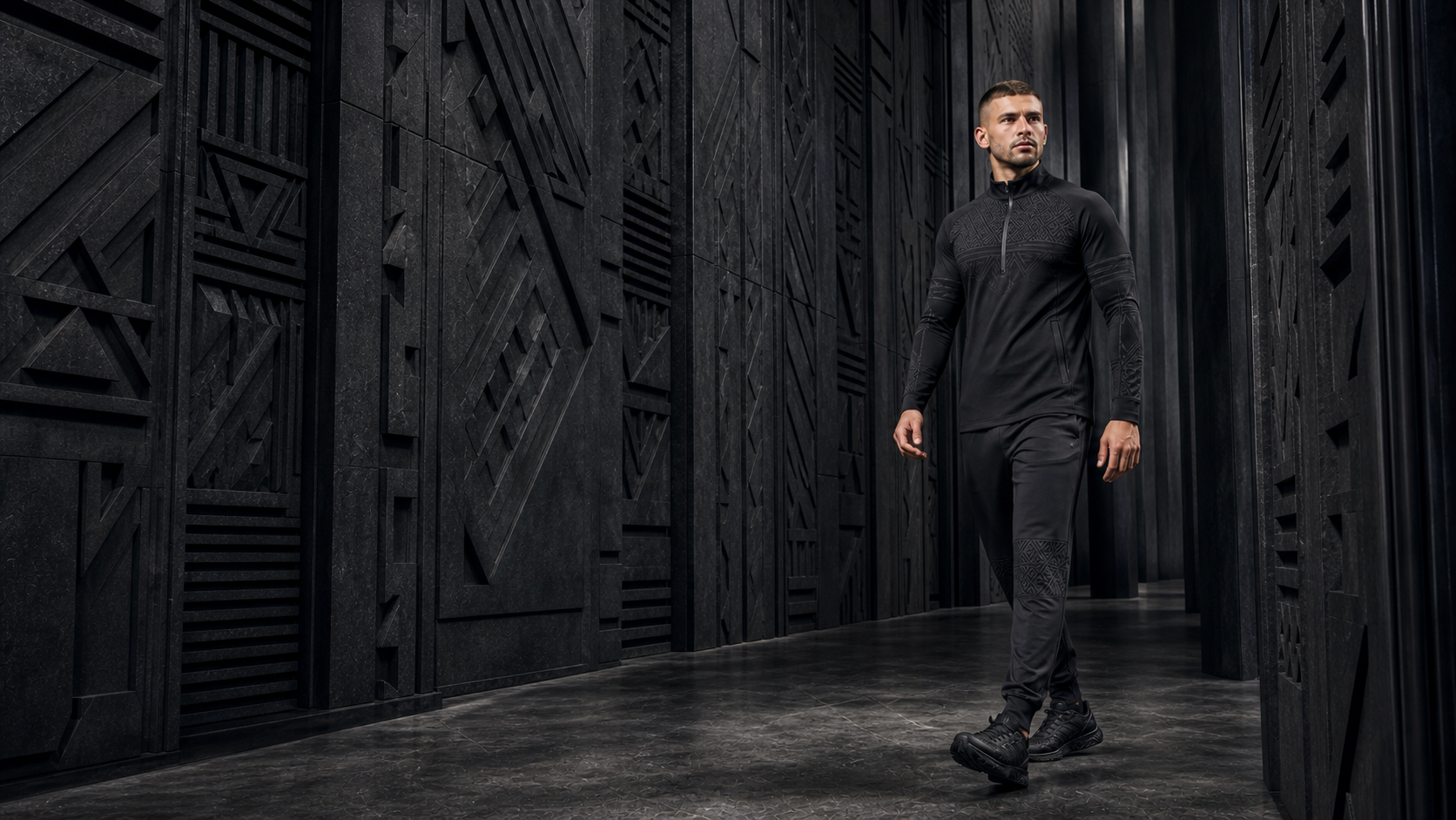 Male model walking through an intricate carved graphite corridor
